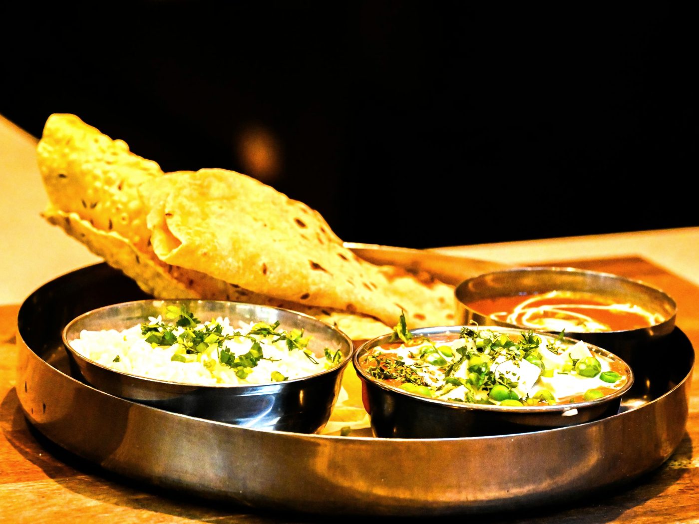 A Nepalese thali tray with dal, curry, rice and fresh roti